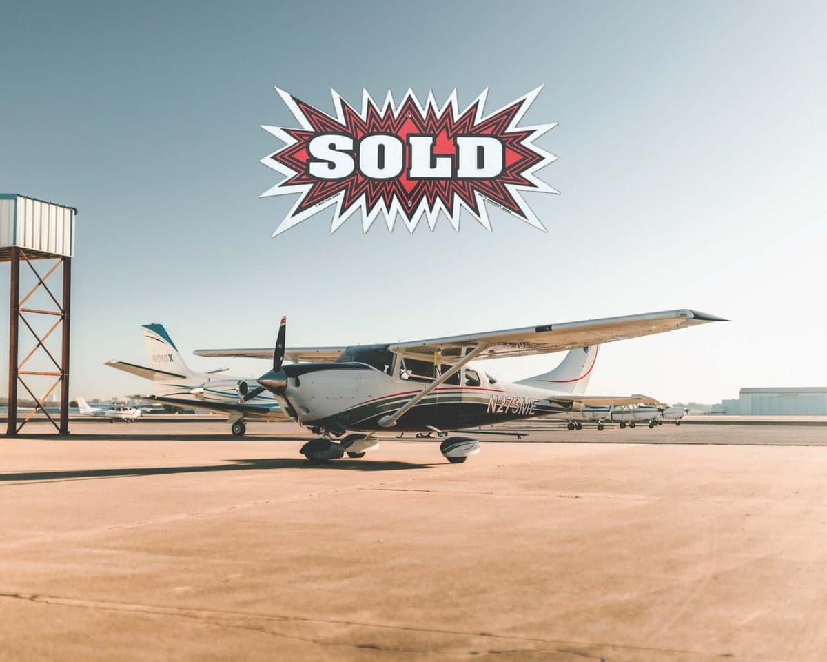Cessna 206 Turbo Stationair TC aircraft N273ME on the ground with a SOLD graphic overlayed.