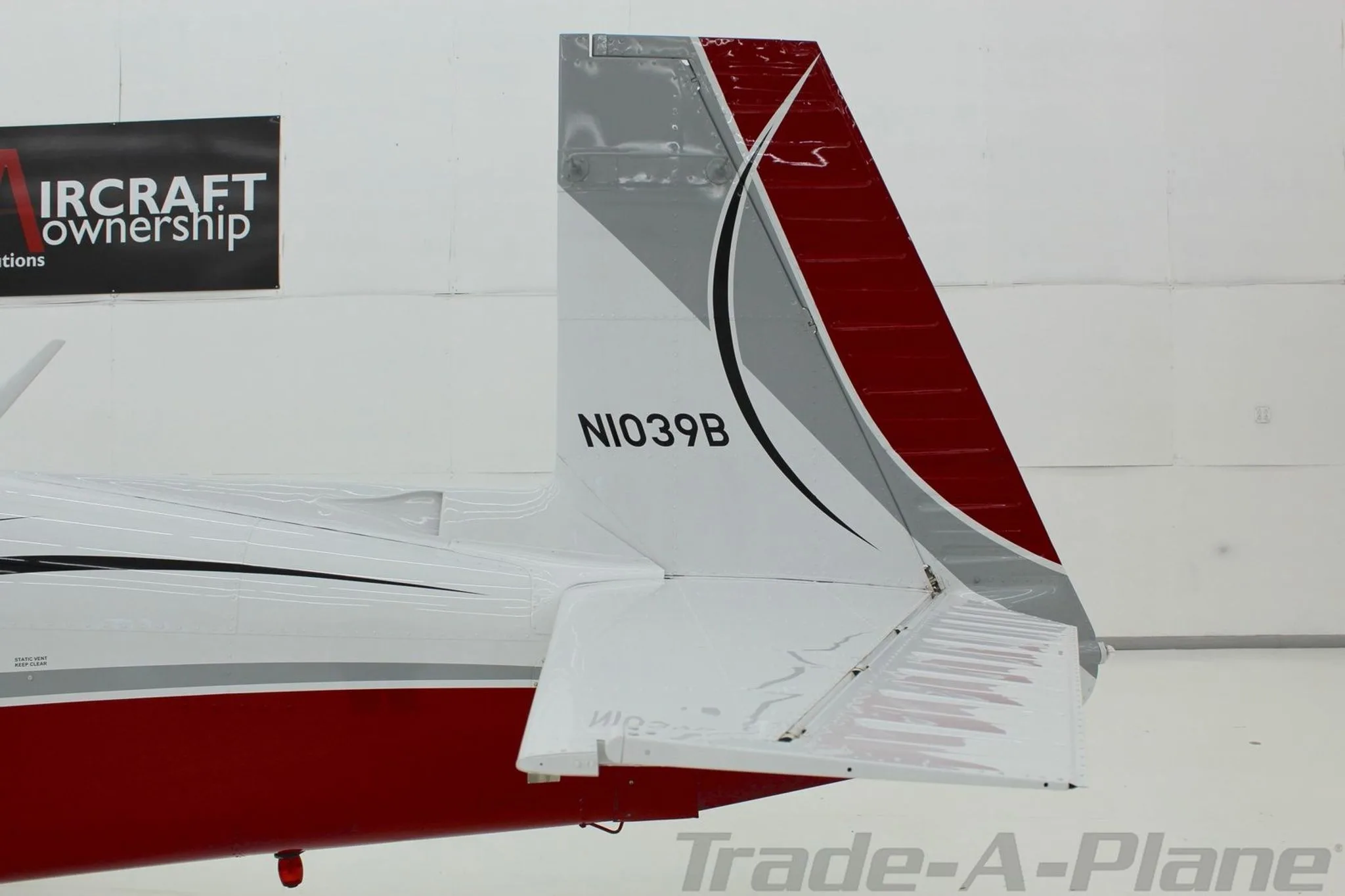 A close-up of the tail section of the Mooney N1039B, showing the registration.
