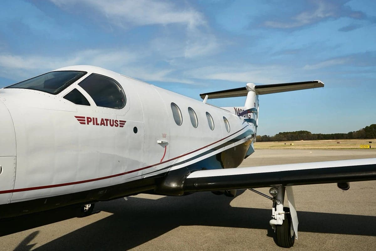 Close up of the side of a Pilatus PC-12NG on the tarmac.
