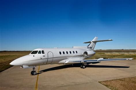 A white Hawker 800XP business jet, registration XA-SON, parked on a tarmac under a clear blue sky.
