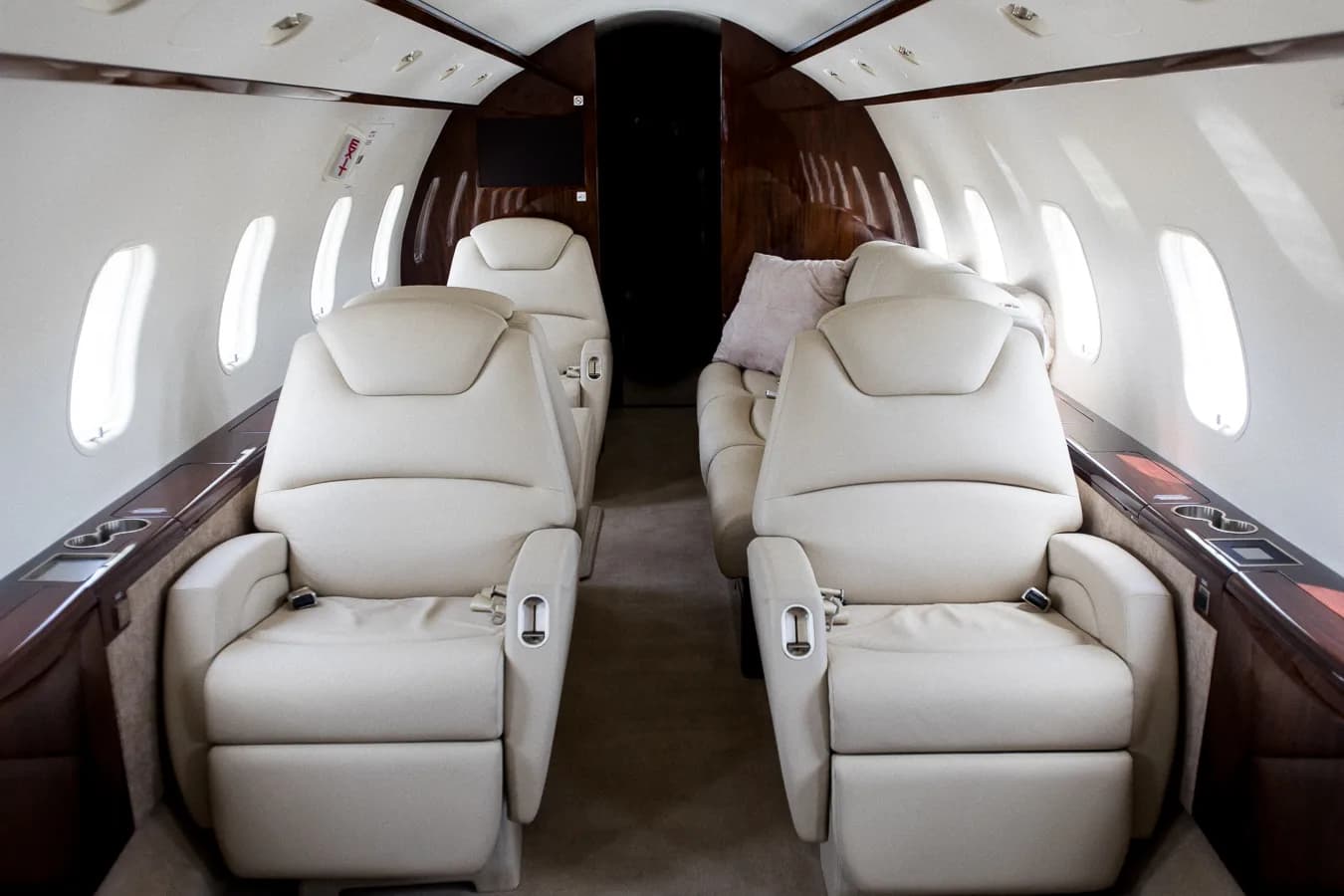 View of the aircraft interior with leather seats and wood trim.