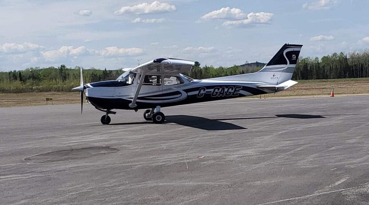 A Cessna aircraft is parked on an airport tarmac.