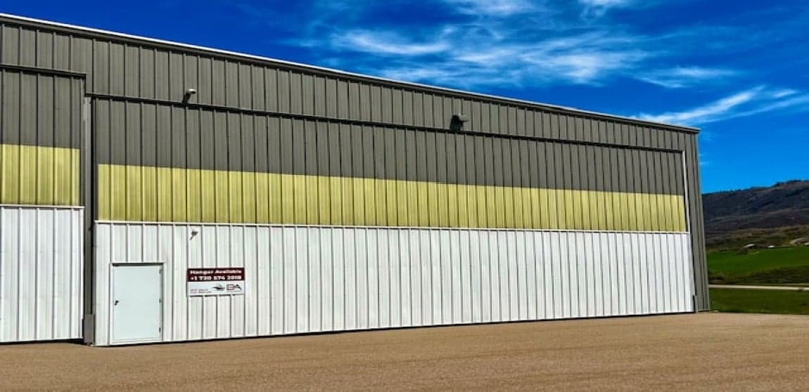 A rendering of a hangar with two business jets parked outside.