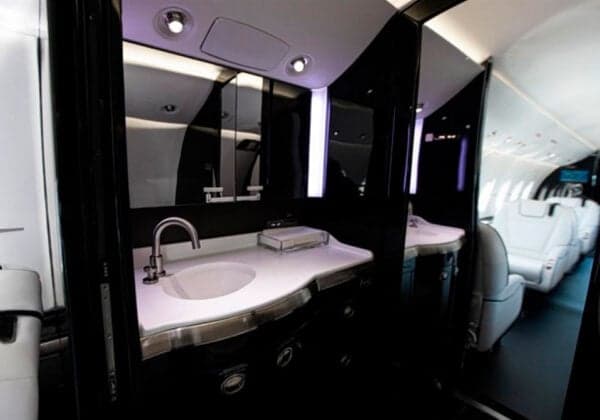 The lavatory of a Hawker jet with a sink and mirror.