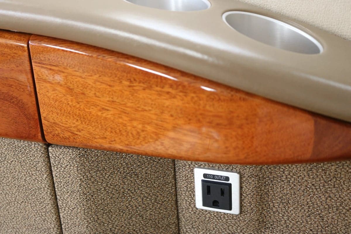 Close-up of a Citation CJ2 cabin interior with a 110 outlet.
