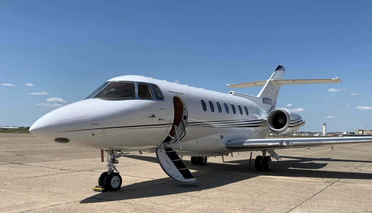 Hawker 800XP on the tarmac with the airstair door open.