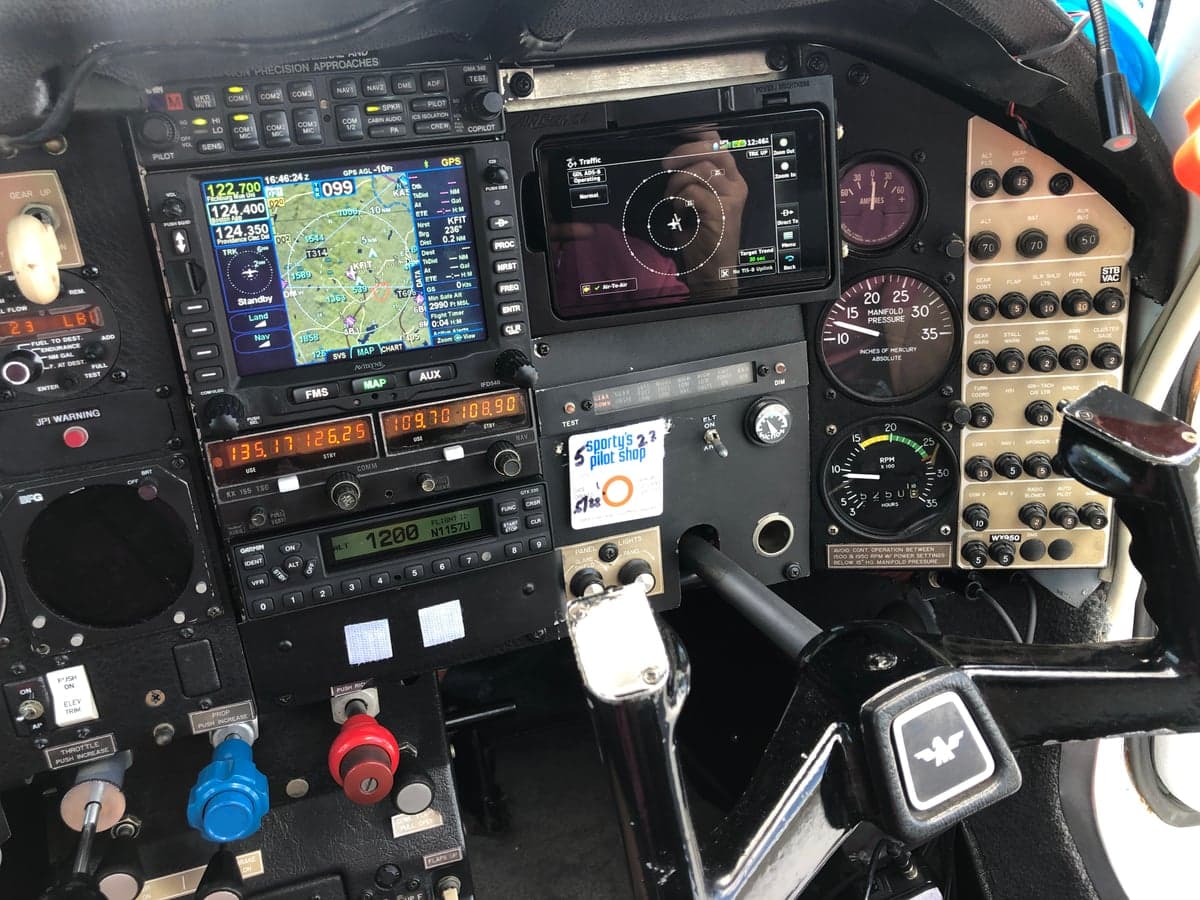 Wide view of the aircraft's cockpit instrument panel and avionics.