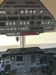 The cockpit of an aircraft with many instruments and controls.
