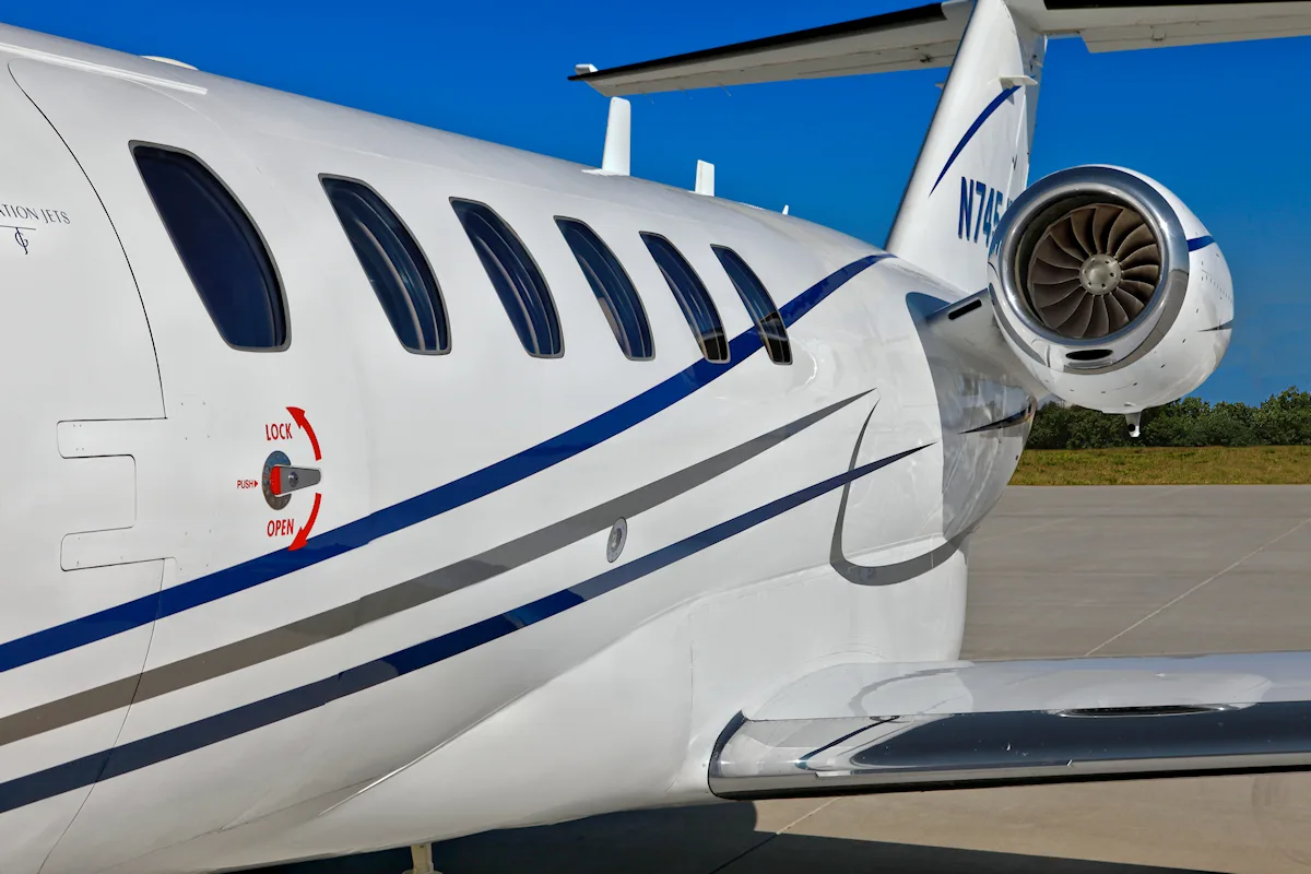 Close-up of the tail and engine of a Cessna Citation CJ3 with registration N745JS.