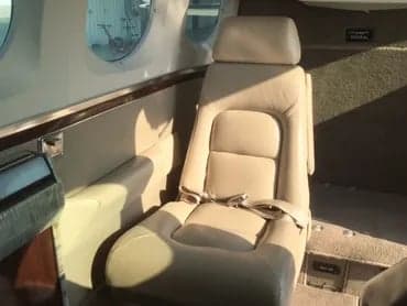A single seat in the cabin of a Cessna 421C Golden Eagle aircraft.
