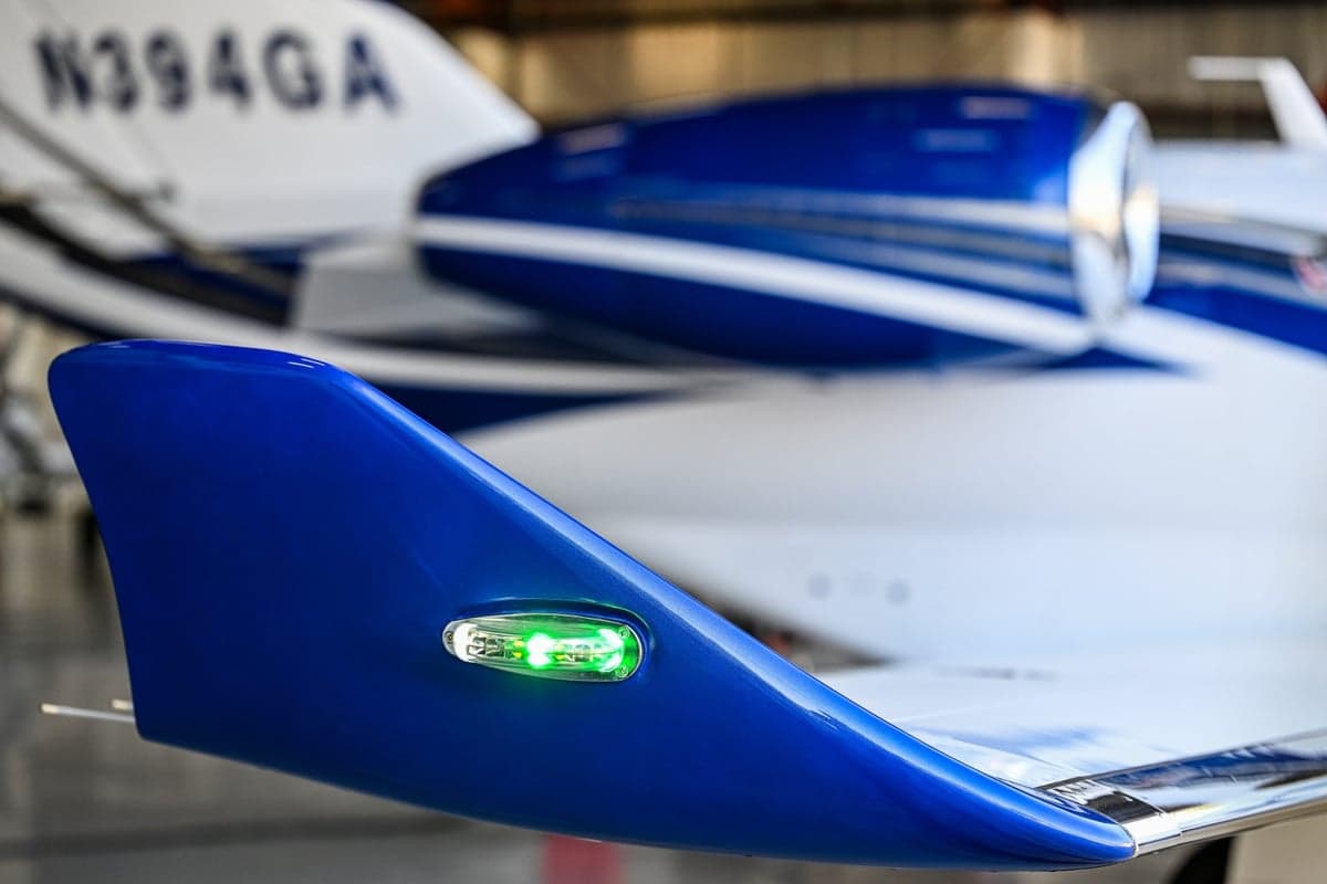 Close-up of the blue wingtip with a green navigation light, with N394GA visible in the background.