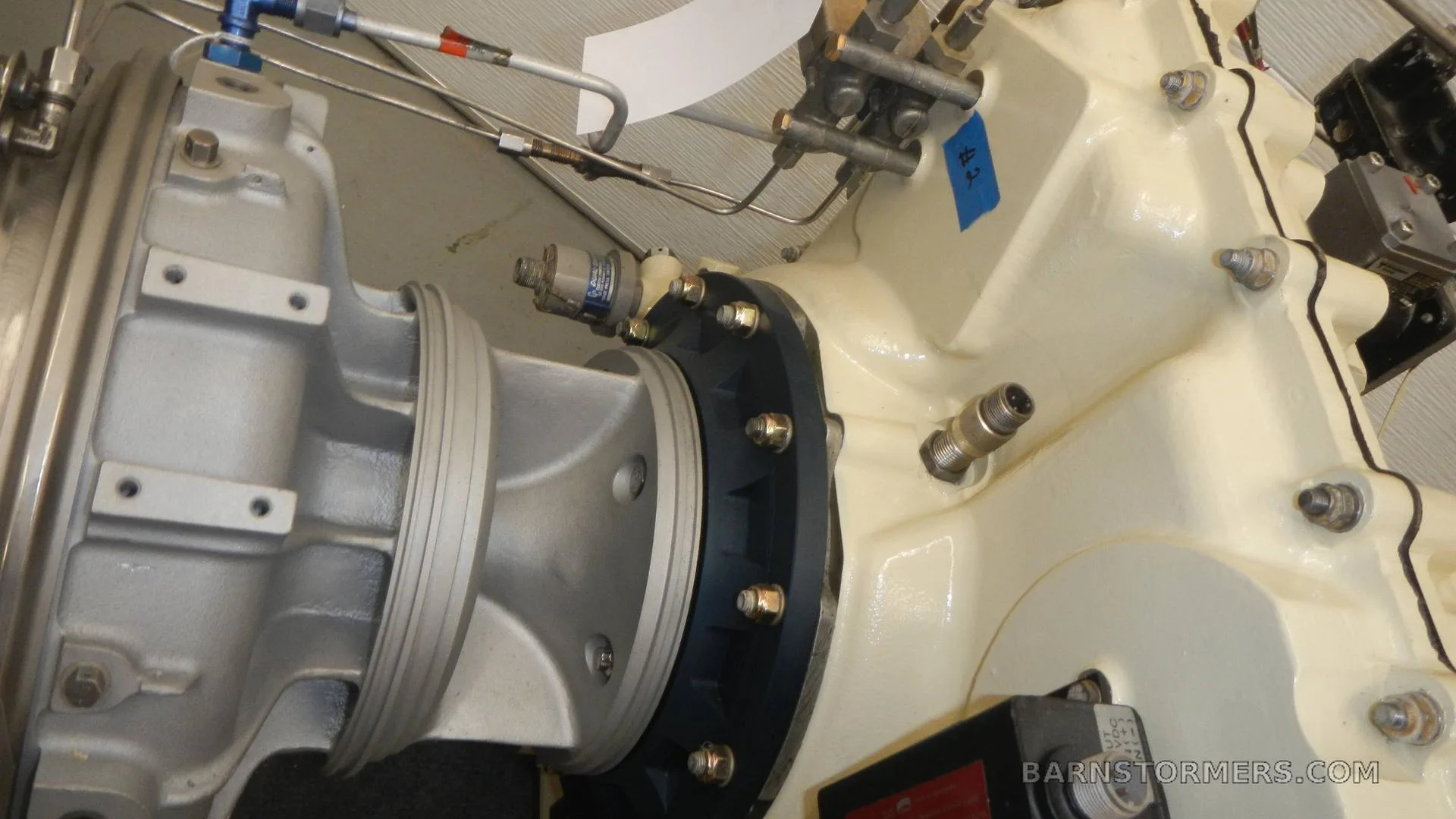 A close-up view of the connection point between two major sections of an aircraft engine.