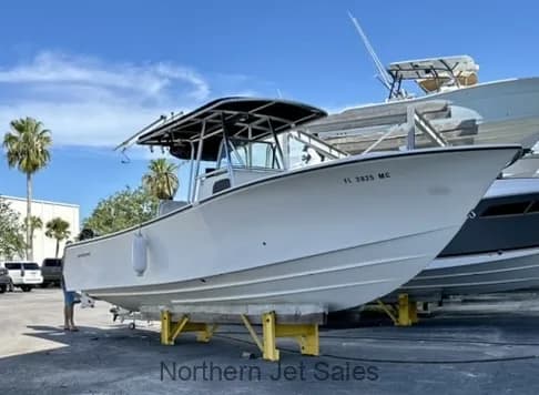 Side view of the white boat on a trailer.