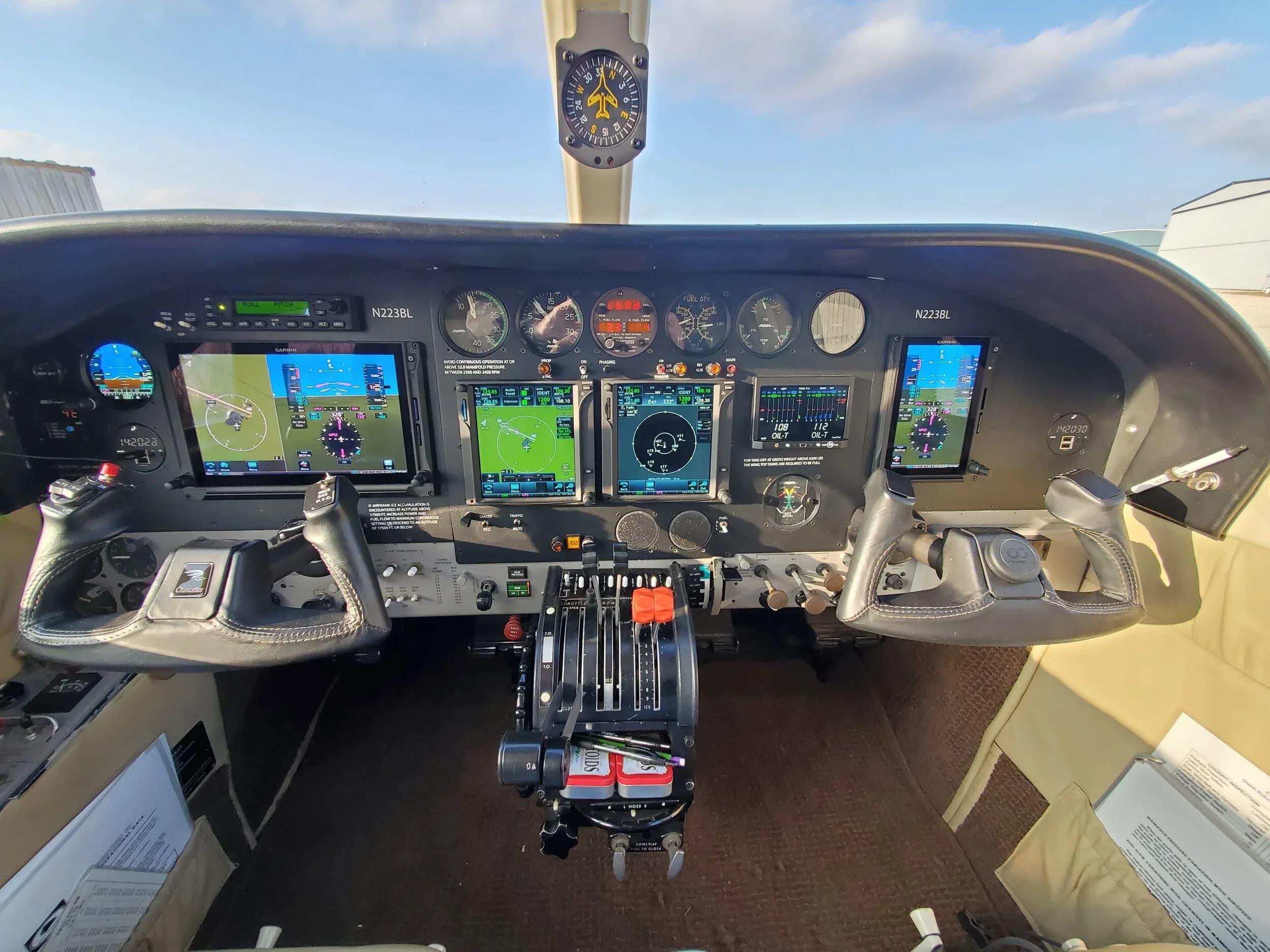 The cockpit of a Cessna 340 features a modern glass panel with multiple digital displays, traditional analog gauges, and dual yokes.