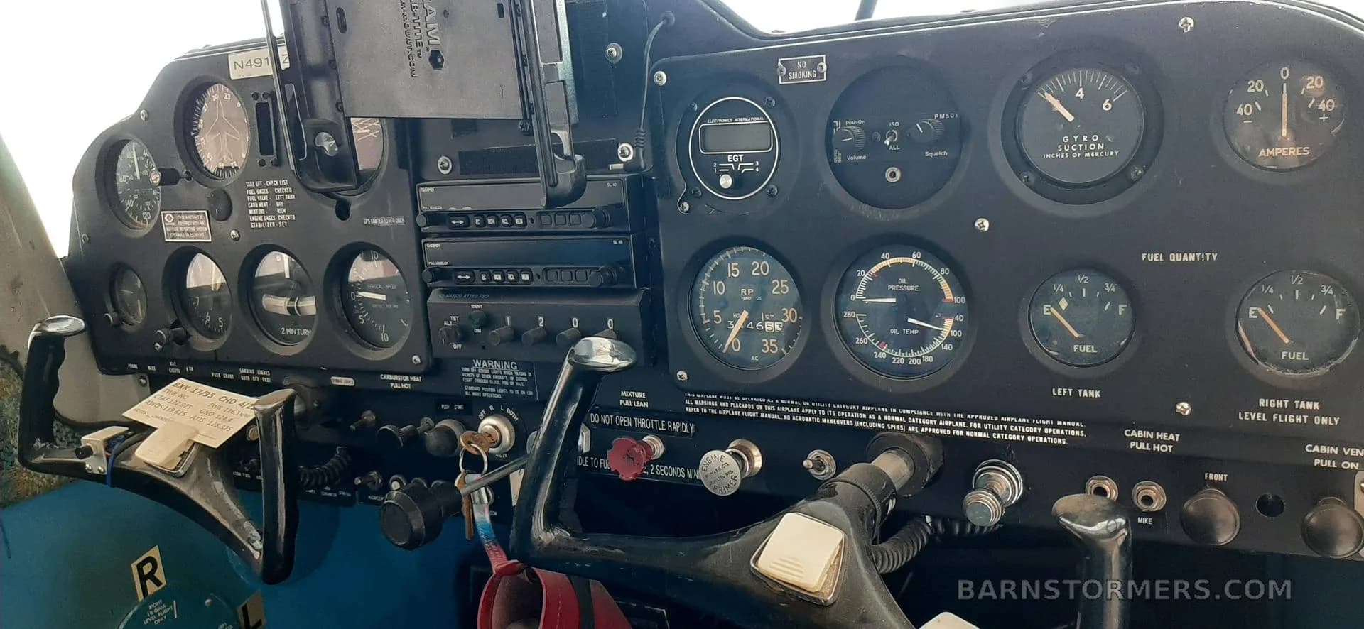 The instrument panel of an aircraft, featuring various gauges, avionics, and flight controls.