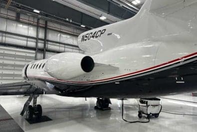 Rear side view of the N504CP aircraft in a hangar.