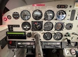 Close-up of the aircraft instrument panel with various gauges.