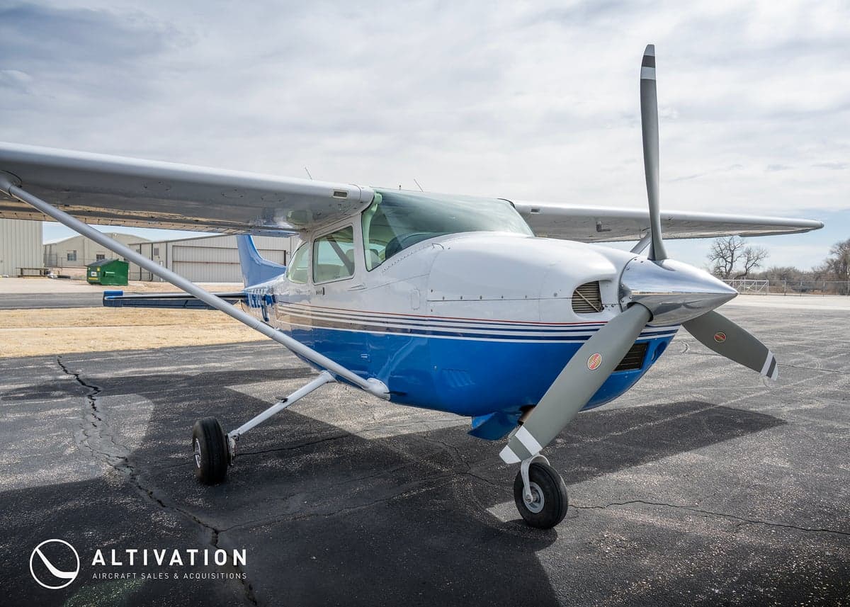 A close-up view of the front of a Cessna aircraft, highlighting the propeller and nose.