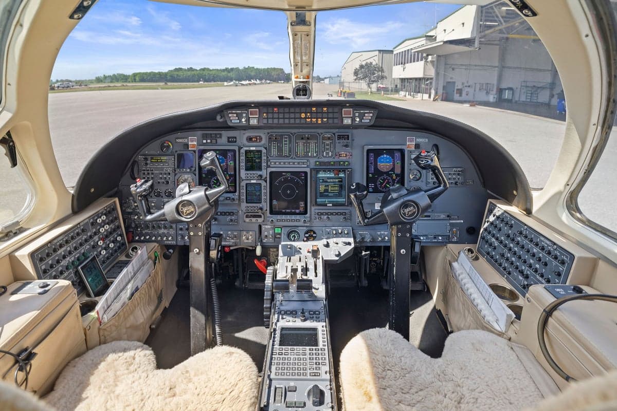 The cockpit of the aircraft features a full instrument panel and sheepskin seat covers.