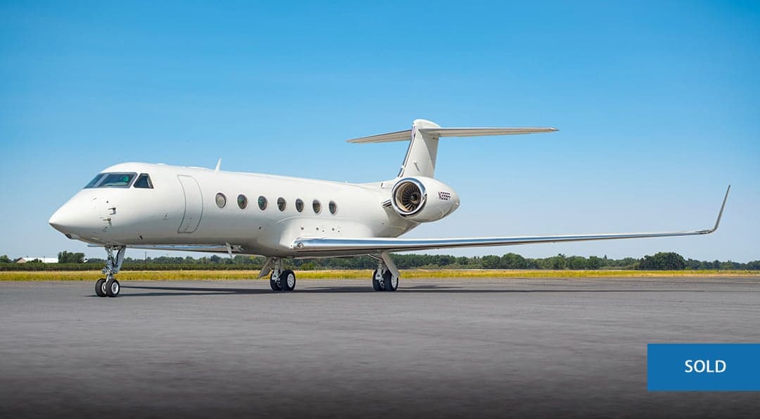 A white Gulfstream G550 aircraft with tail number N399FF is parked on the tarmac on a sunny day.