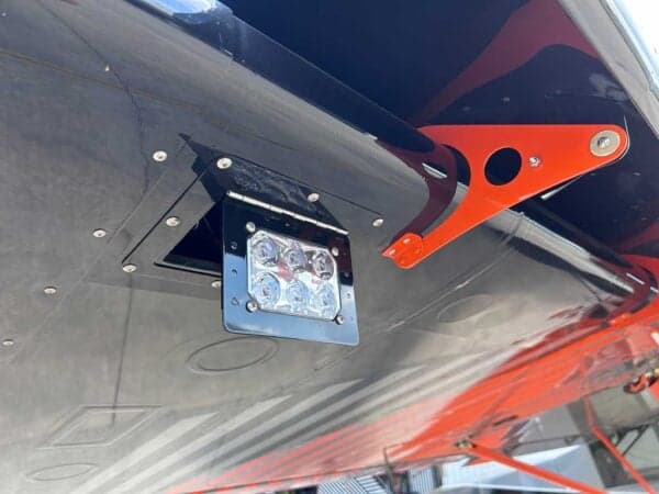 Close-up of the aircraft's landing light and orange support structure.