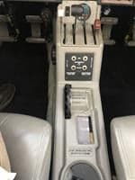 The center console of the aircraft cockpit features various controls and switches.