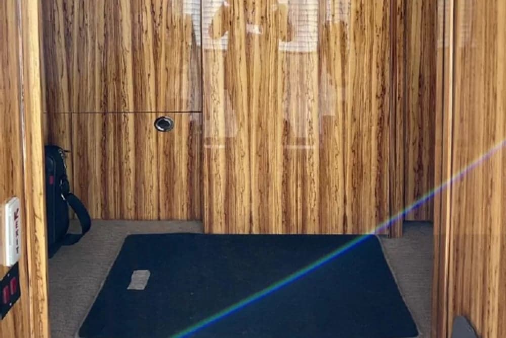 View of the aircraft's lavatory with wood paneling.