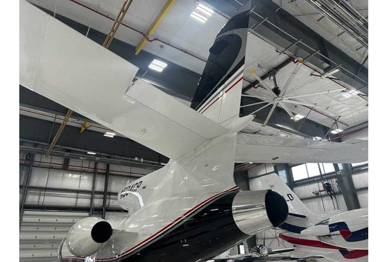 Rear view of the N504CP aircraft in a hangar.