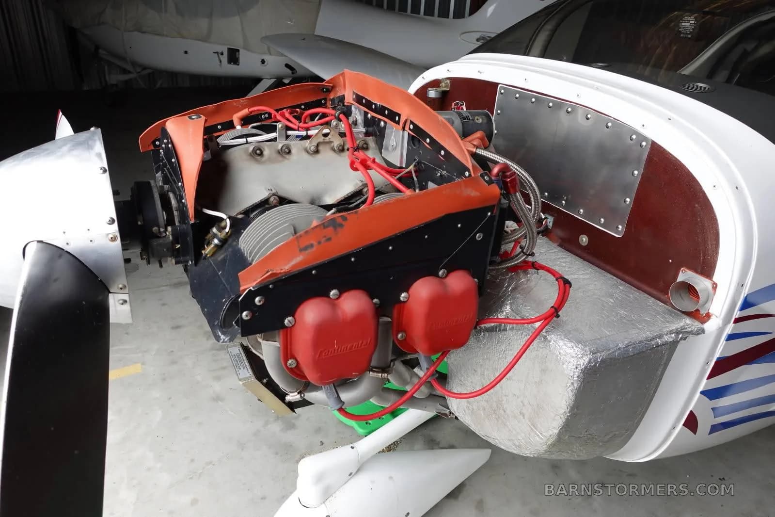 The exposed engine of a Europa aircraft, showing the Continental engine with red spark plug covers.