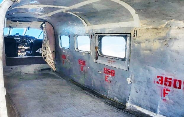View of the aircraft's interior cabin with windows and markings.