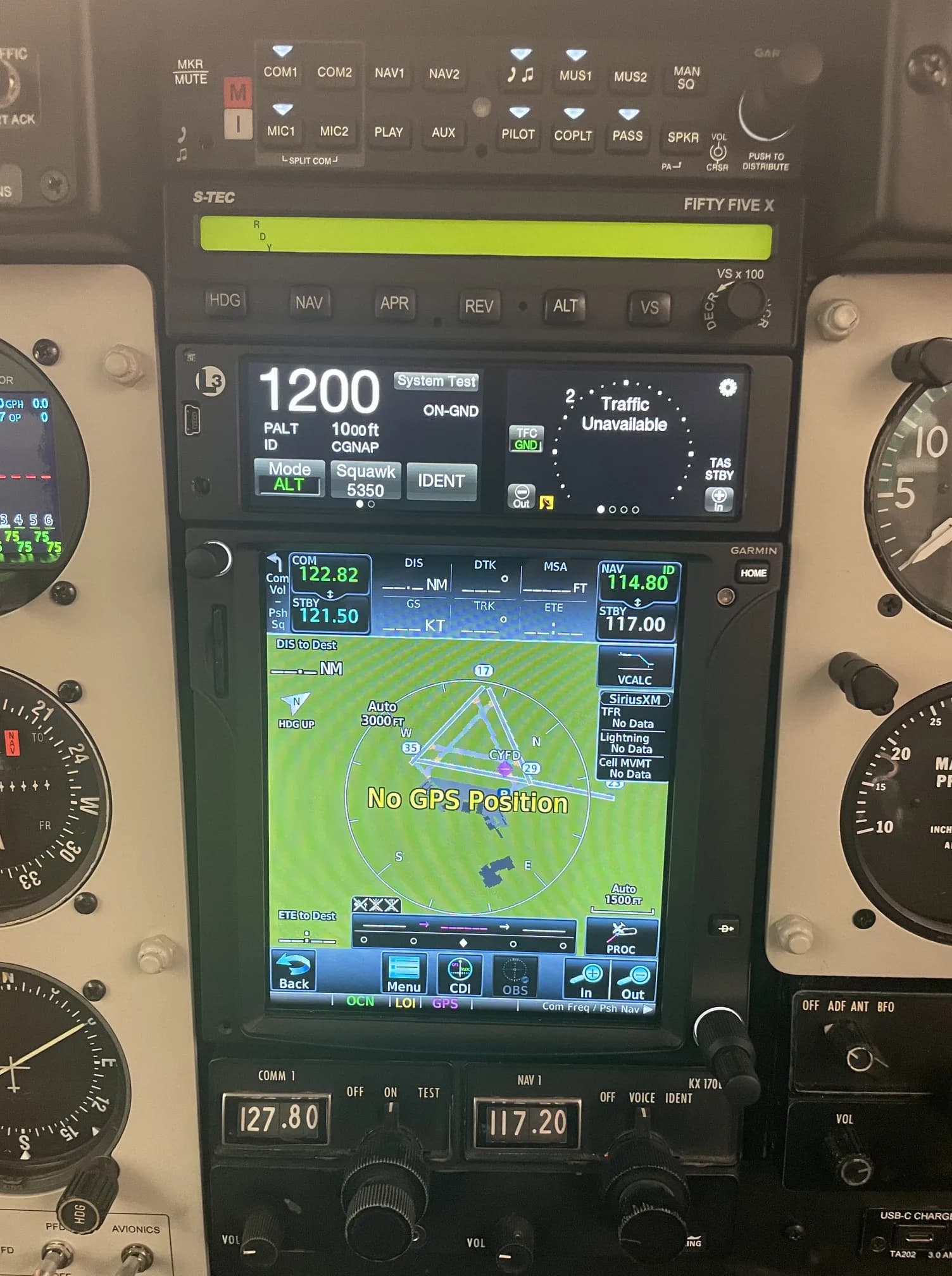 A detailed view of the aircraft's avionics stack, featuring an S-TEC autopilot and Garmin GPS display.