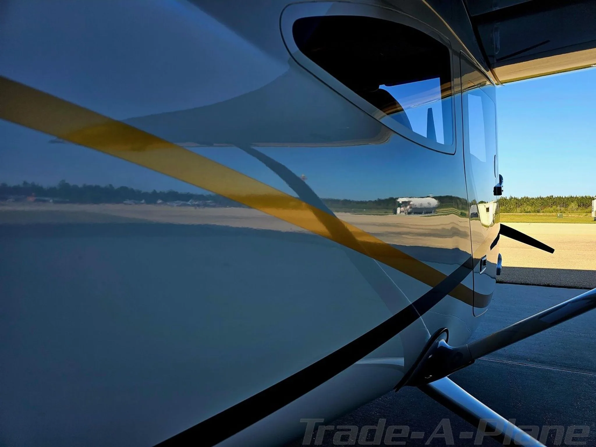 A close-up view of the reflective white and gold fuselage of the I600 aircraft.