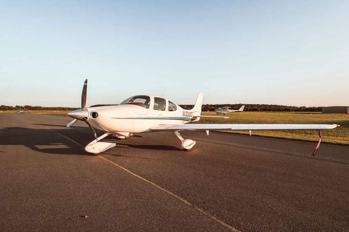 Cirrus SR22 aircraft N133CD parked on the tarmac, side view.