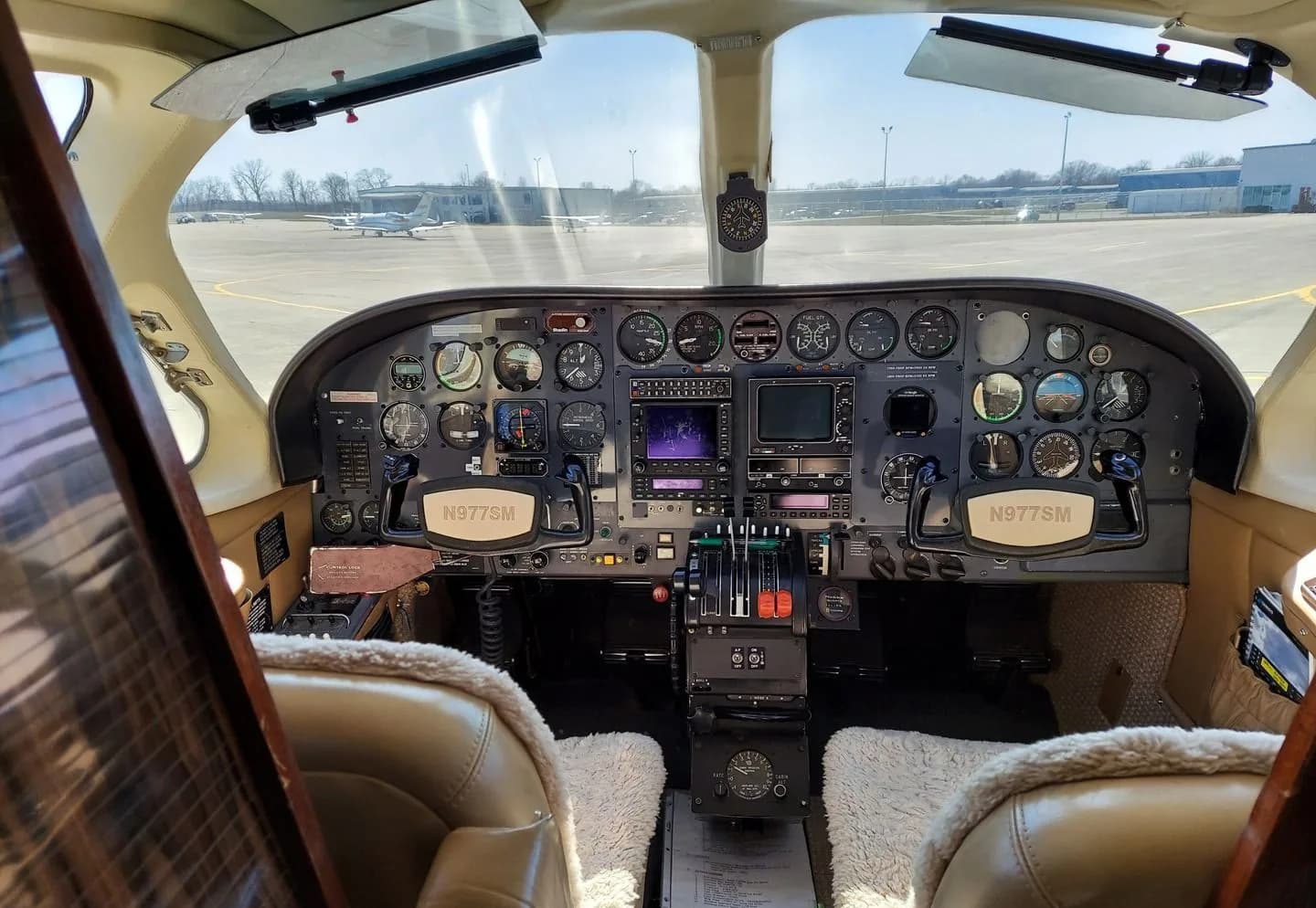 The cockpit of a Cessna 414 aircraft with the instrument panel and yokes visible.