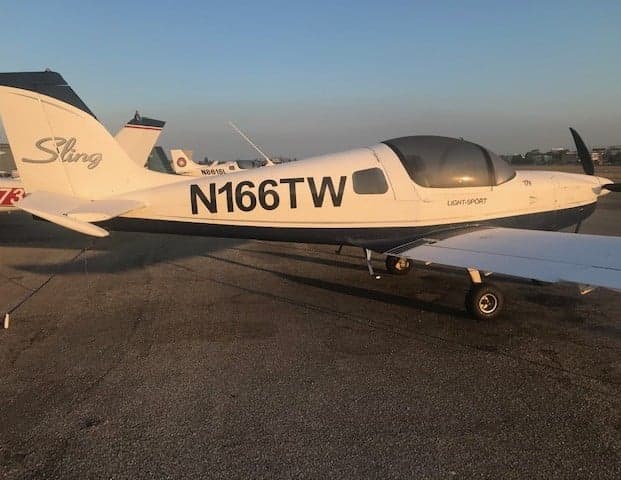 Side view of the Sling LSA aircraft with registration N166TW on the fuselage.