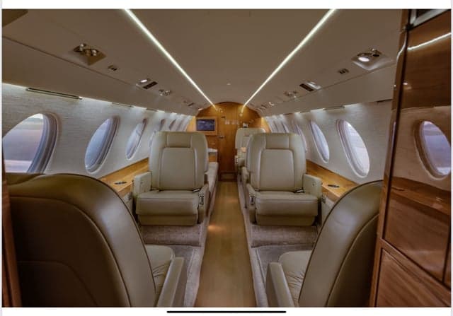 The interior of the Falcon jet, showing the seating arrangement.