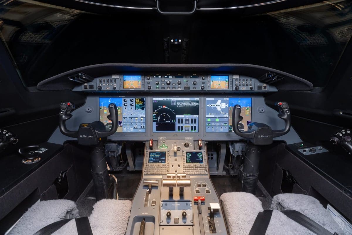 The cockpit of the aircraft features multiple display screens and controls.