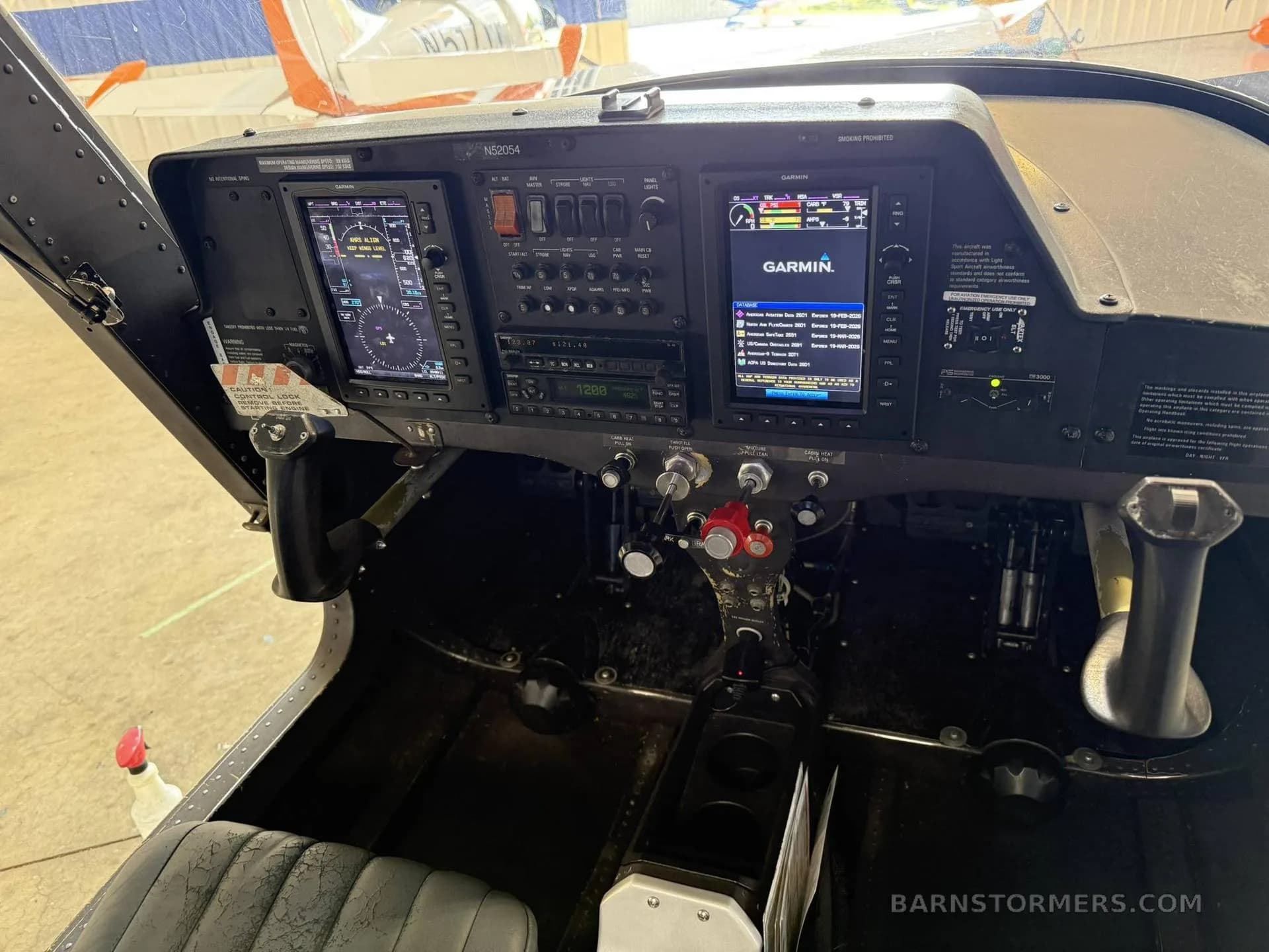 The cockpit of a Cessna Skycatcher, showing the instrument panel with two Garmin G1000 displays and various controls.