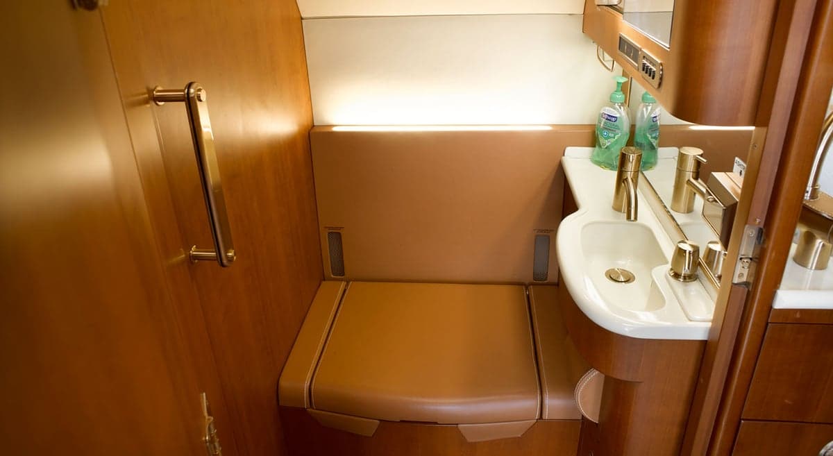 View of the aircraft's lavatory with a sink and seating.