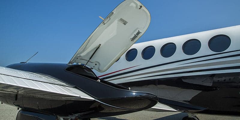 Close up of the King Air aircraft showing the open baggage compartment.
