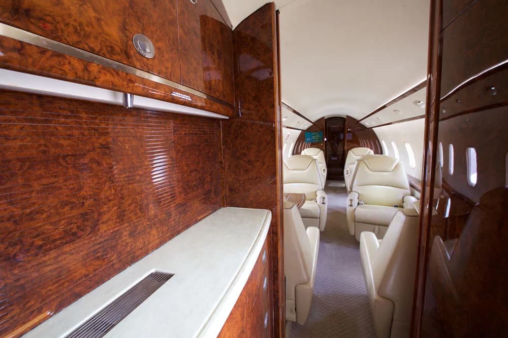 View of the aircraft interior showing the cockpit and wood cabinetry.