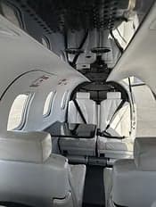 Interior view of the aircraft cabin showing the seating arrangement and overhead details.