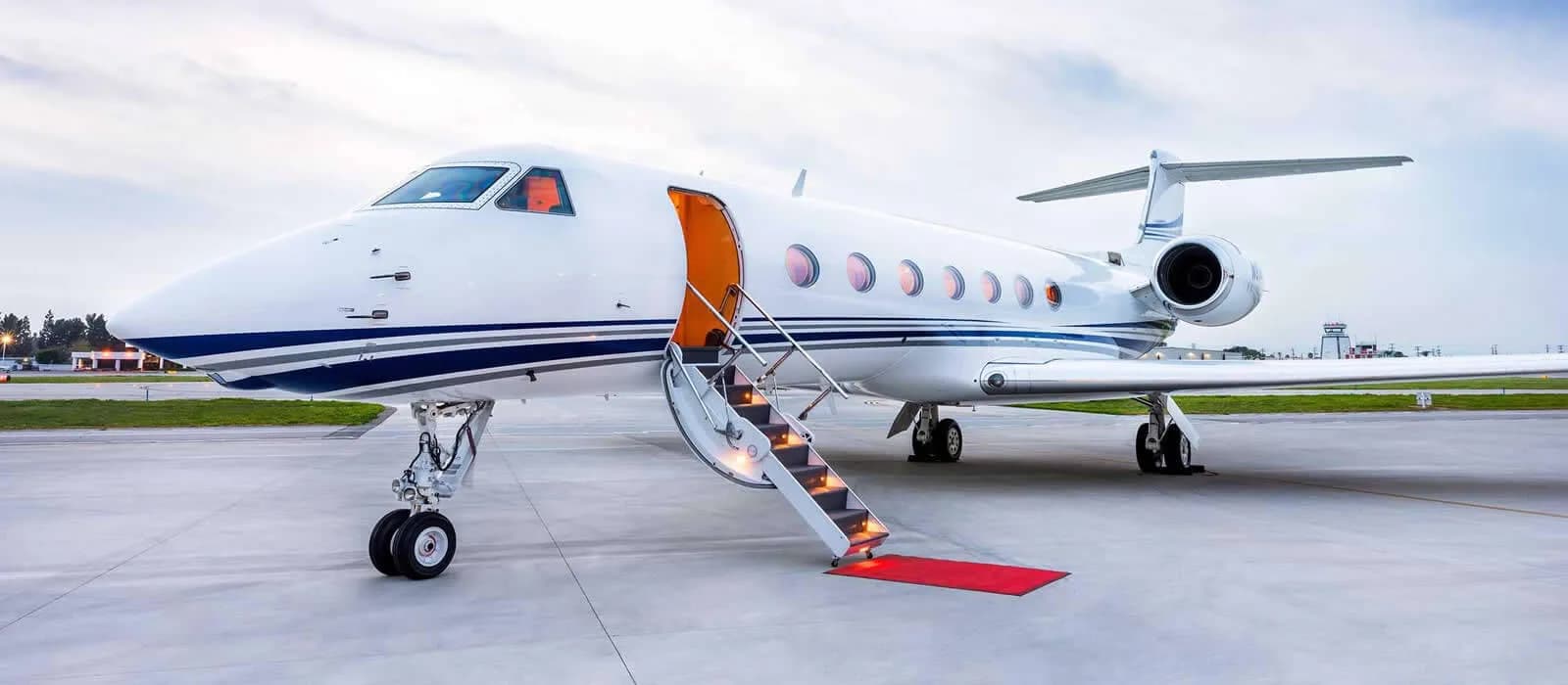 A white Gulfstream jet with an open door and stairs extended.