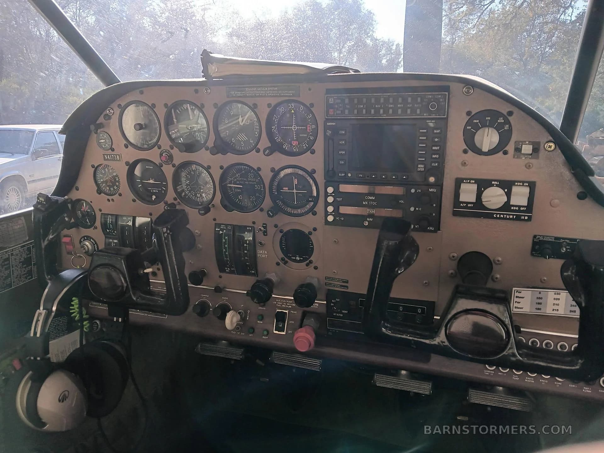 A detailed view of the aircraft's instrument panel with various gauges, avionics, and controls.