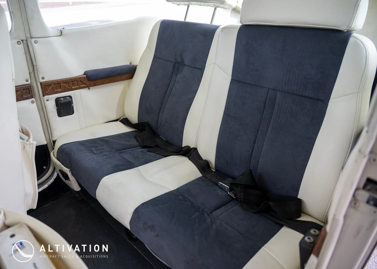 The interior of a Cessna aircraft, showing the open door and cockpit area.