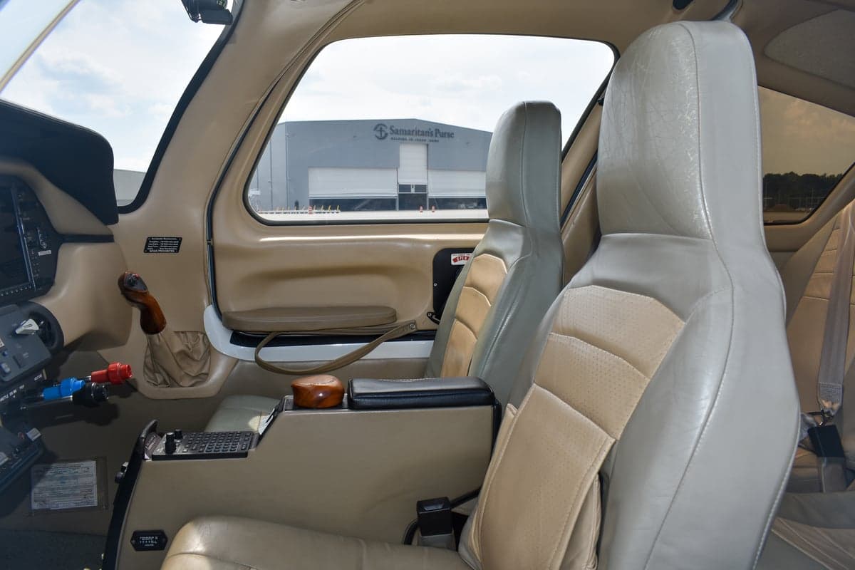 View of the aircraft's cockpit with dual screens and controls.