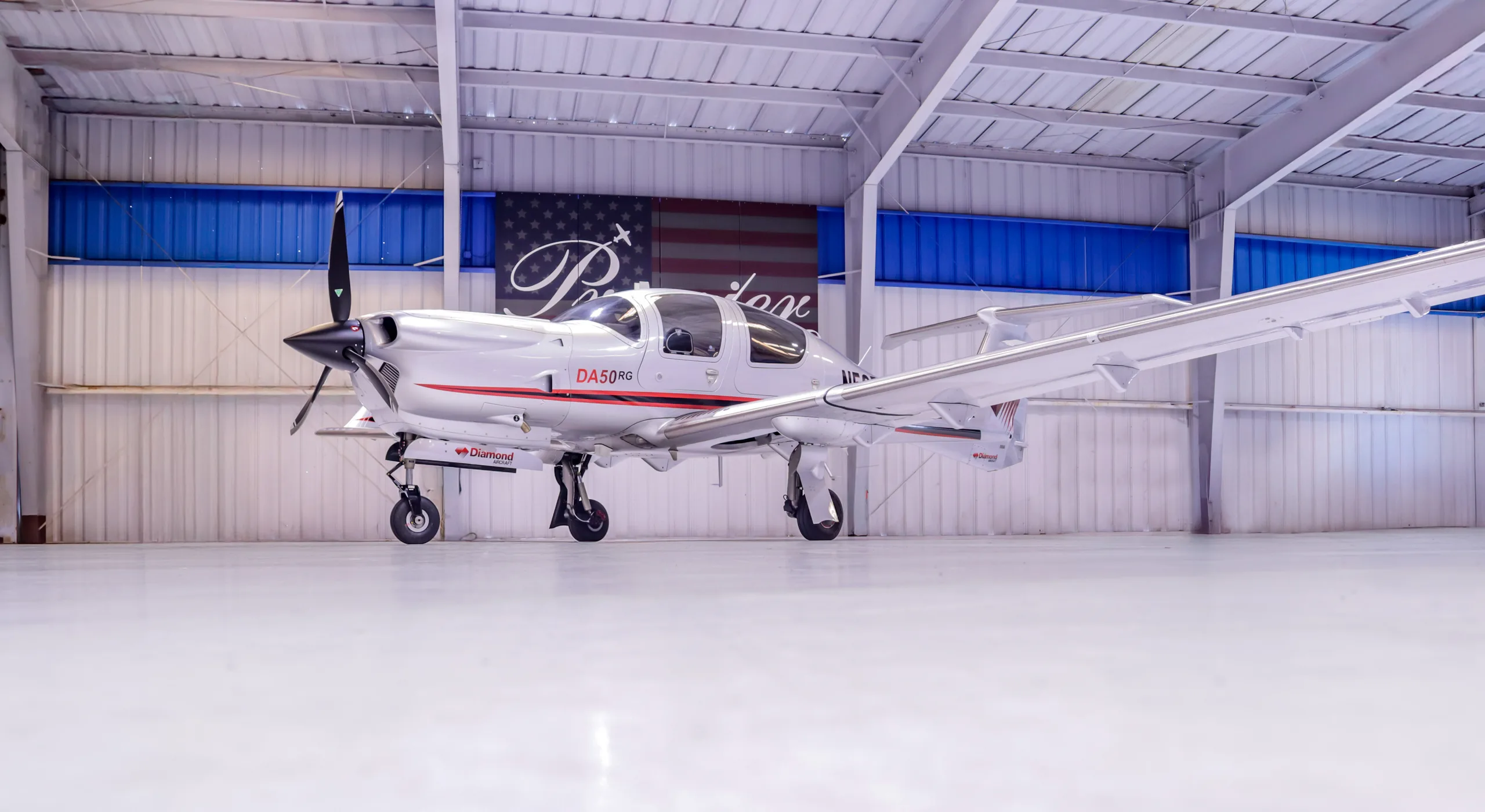 Diamond DA50RG aircraft N565RG parked in a hangar.