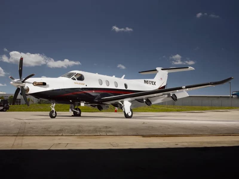 A Pilatus PC-12 aircraft with registration N617EX is parked on the tarmac.