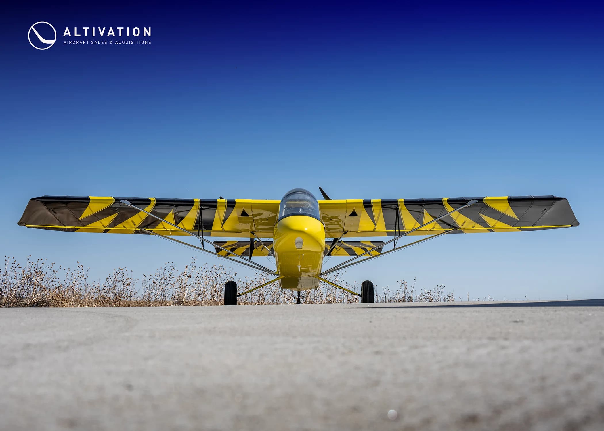 Front view of a yellow and black AirCam on the ground.
