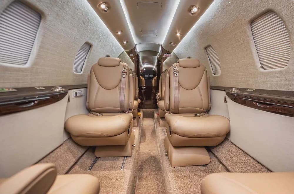 Aircraft cabin with tan leather seats.